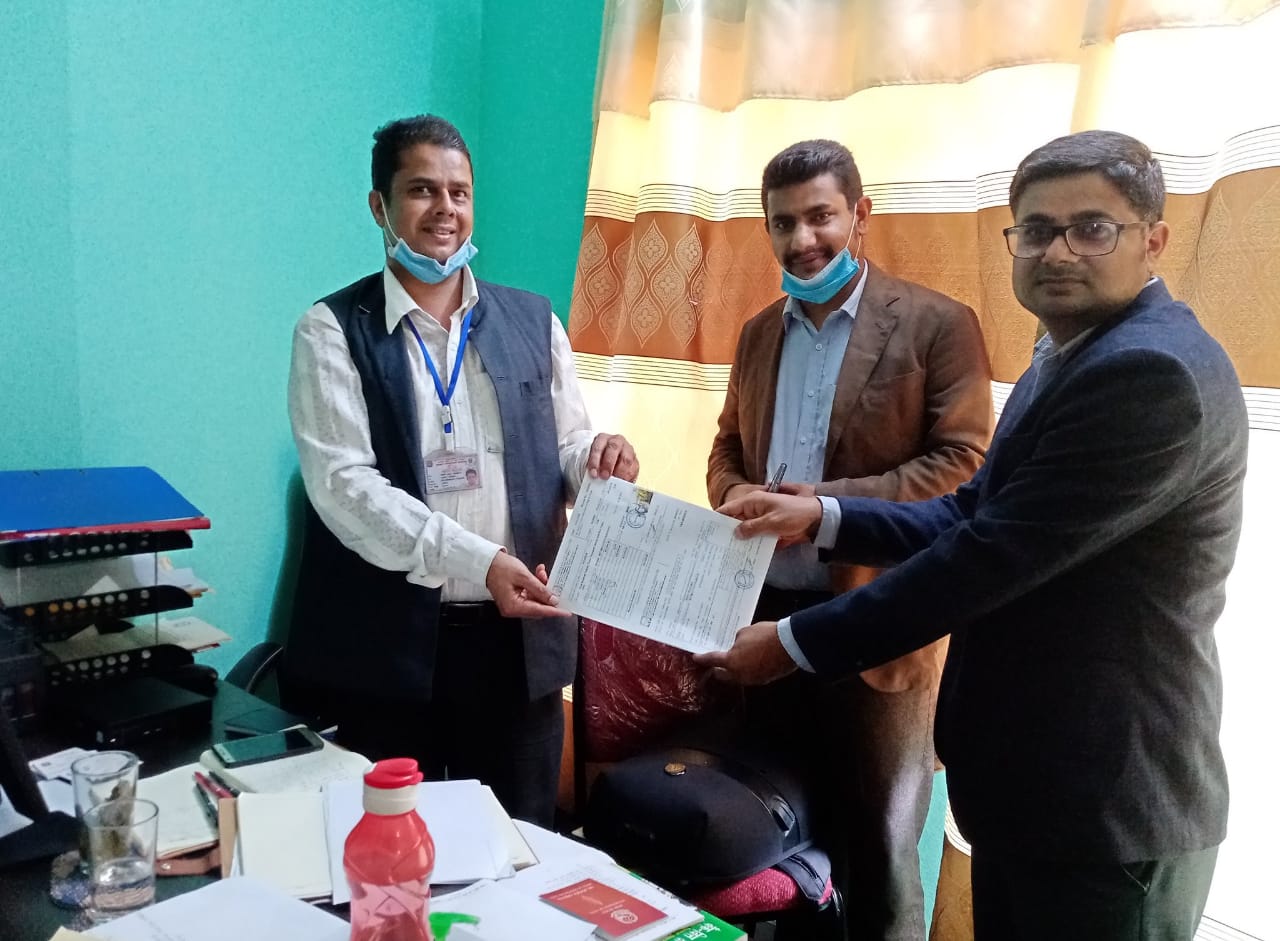 An insurance representative handing over the details of insured journalists to communication registrar of Bagmati Province Rewati Sapkota, in Hetauda, on Thursday, June 18, 2020.