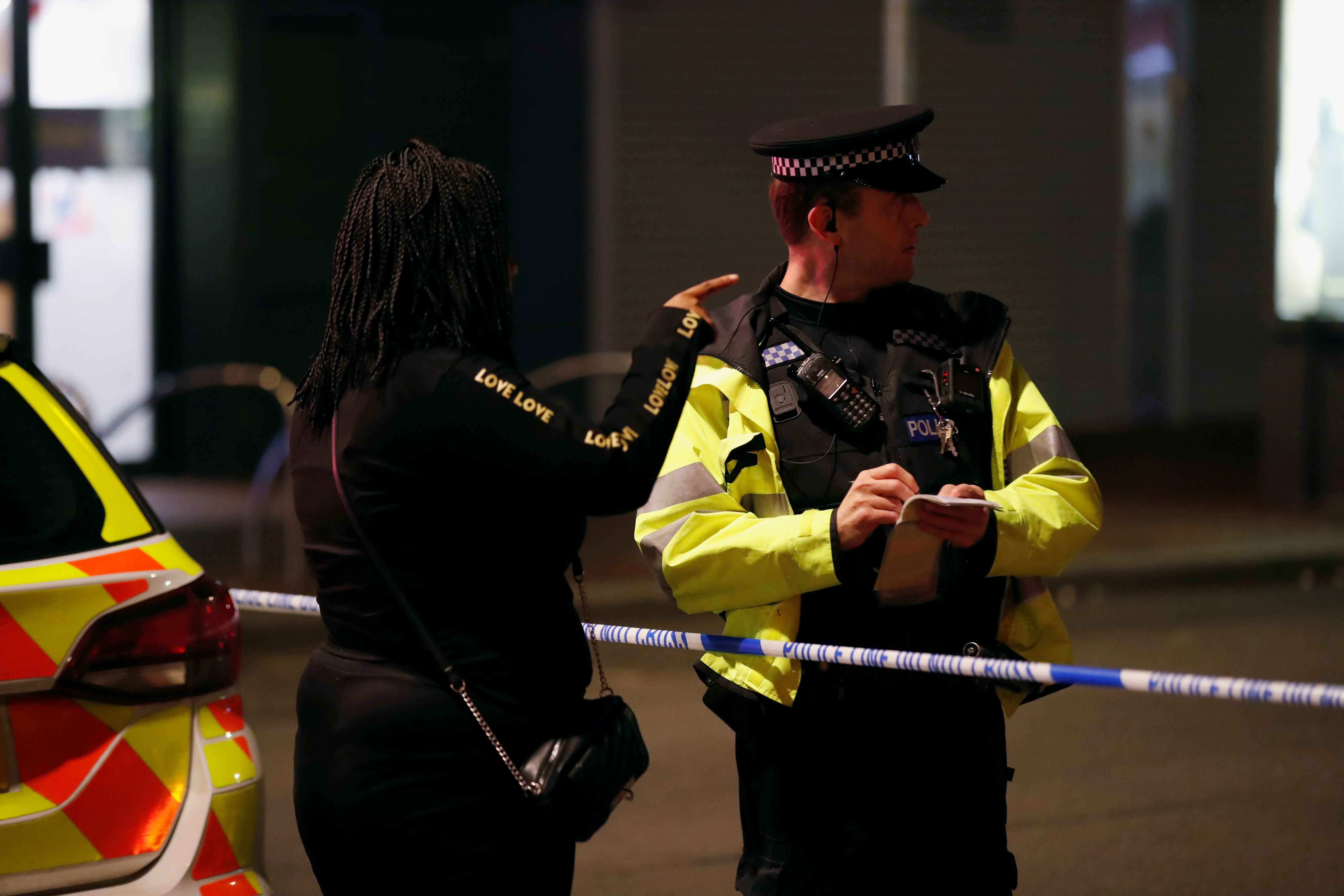 A person speaks to a police officer at a cordon after reported multiple stabbings in Reading, Britain, June 20, 2020. Photo: Reuters