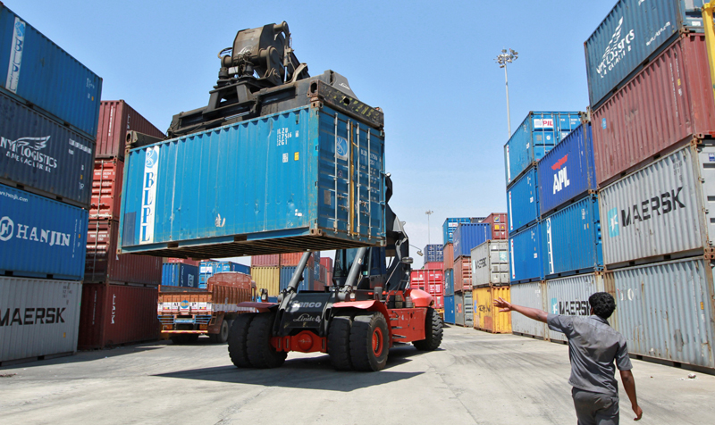 A mobile crane prepares to stack a container at a port in the southern Indian city of Chennai March 16, 2012. Photo: Reuters/File