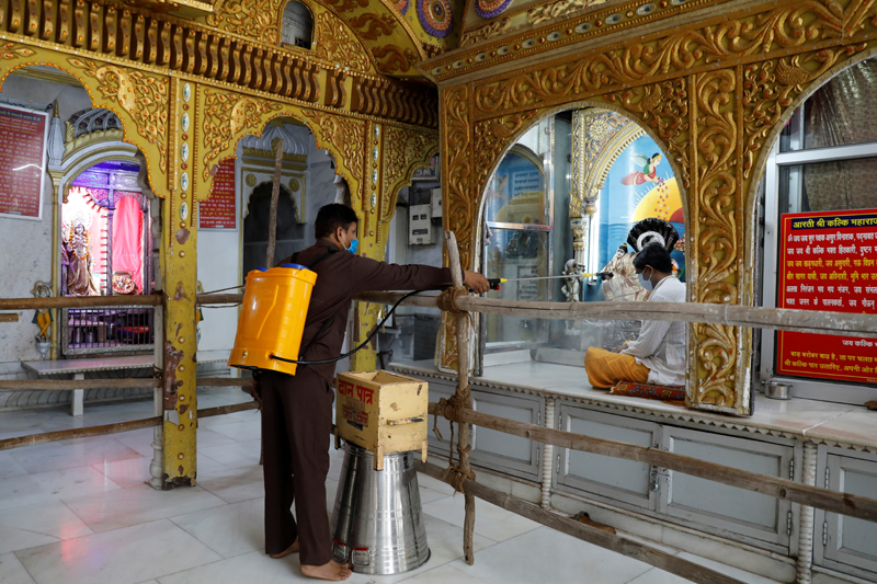 A man disinfects a temple after the opening of most of the religious places after India eases lockdown restrictions that were imposed to slow the spread of the coronavirus disease (COVID-19), in New Delhi, India, June 8, 2020. Photo: Reuters