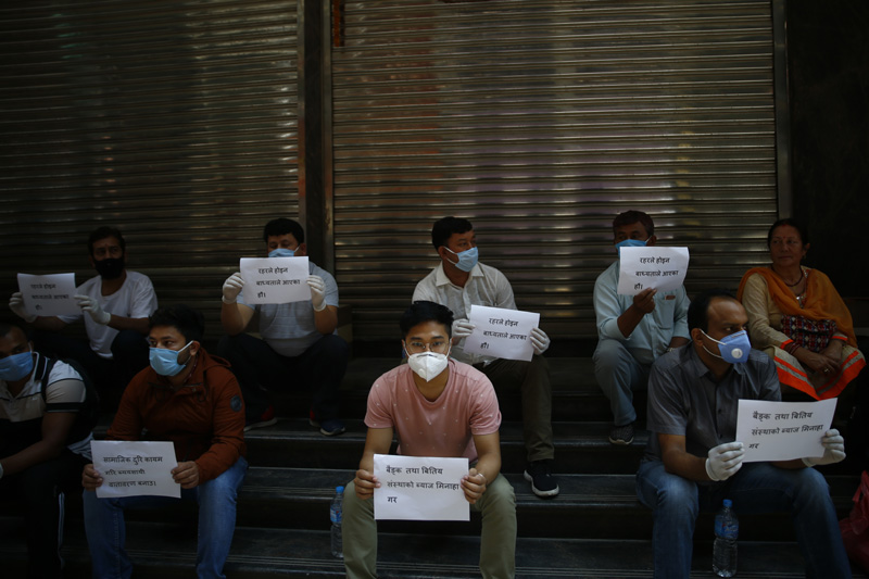 Local businesspersons take part in a protest with their protective face masks on, following safety measures, demanding proper management for business operations to resume during the government-imposed lockdown, in New Road, Kathmandu, on Wednesday, June 10, 2020. Photo: Skanda Gautam/THT