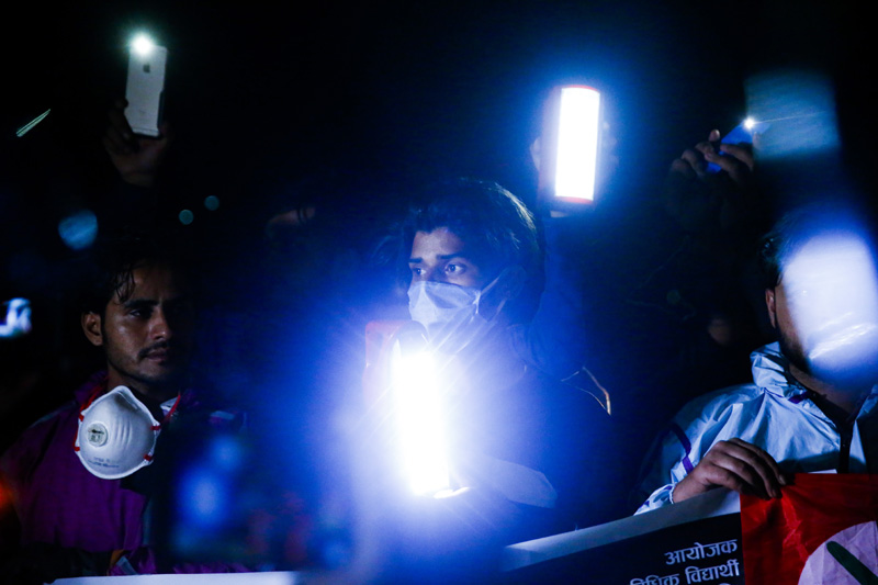 Agitated cadres of Nepali Congress affiliated Nepal Student Union take part in a torch protest at midnight in Kathmandu, on Friday, June 19, 2020. The students took to the streets demanding justice for the Dalit youth killed along with his five friends in Chaurjahari, Rukum west. NSU also demanded justice for the woman who was allegedly gang-raped while staying at a Kailali based quarantine facility and condemned the governmentu2019s dull response to coronavirus crisis. Photo: Skanda Gautam/THT