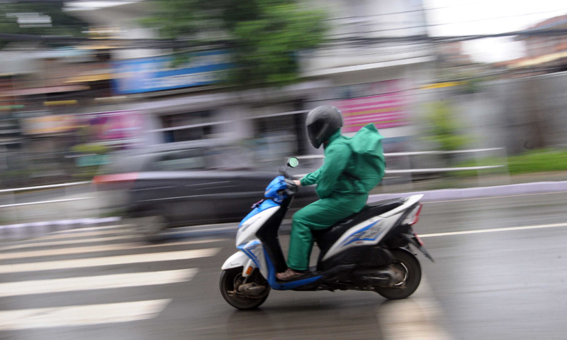 Motorbike riders appear in raincoats on the road as monsoon brings heavy rain, in Jawalakhel, Lalitpur, on Thursday, June 25, 2020. Photo: Balkrishna Thapa Chhetri/THT