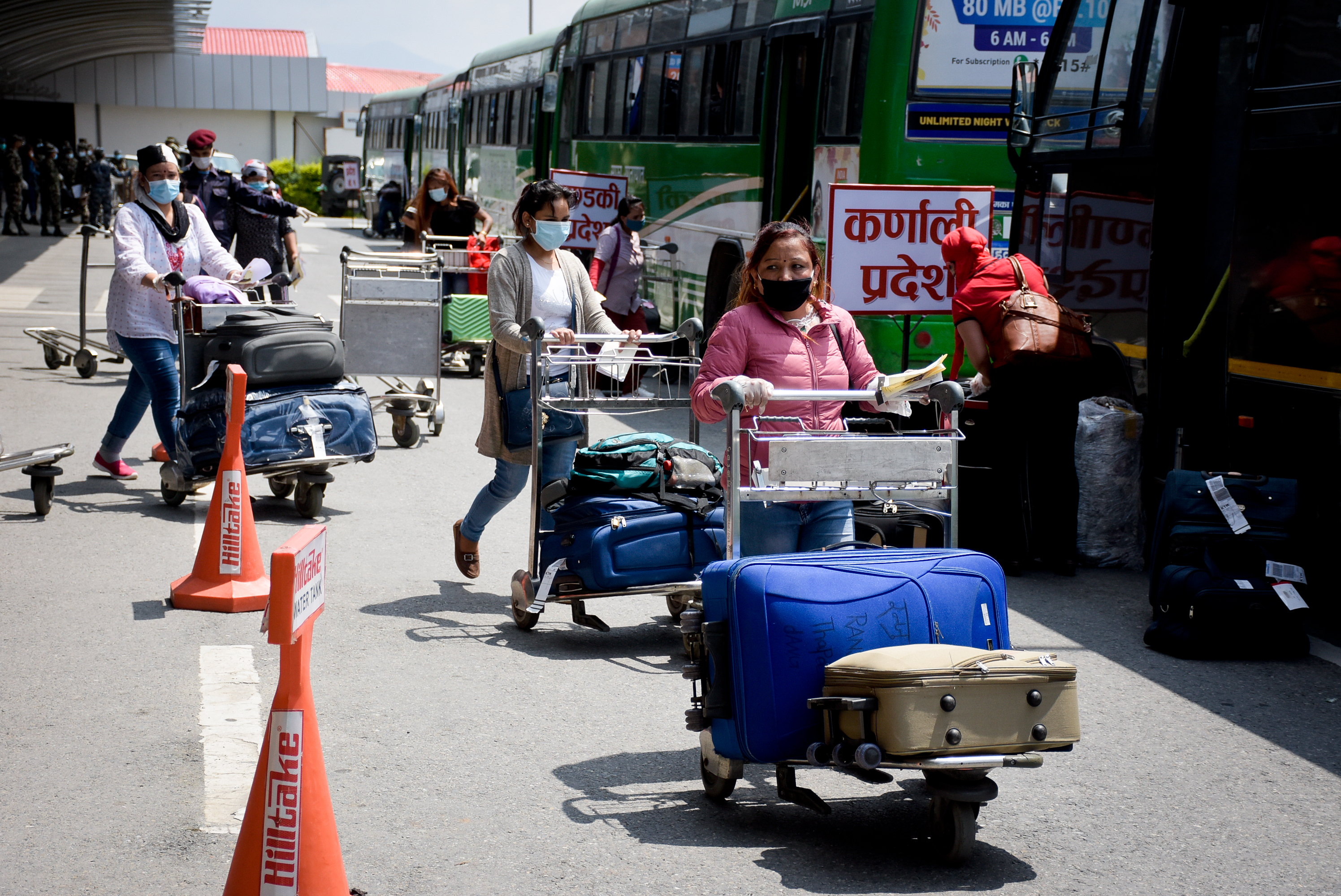 Nepali migrant workers previously stranded in Kuwait due to restrictions imposed on travelling, as a preventive measure against the spread of coronavirus infection, are seen arriving at the Tribhuvan International Airport, in Kathmandu, on June 11, 2020. Photo: Naresh Shrestha/THT