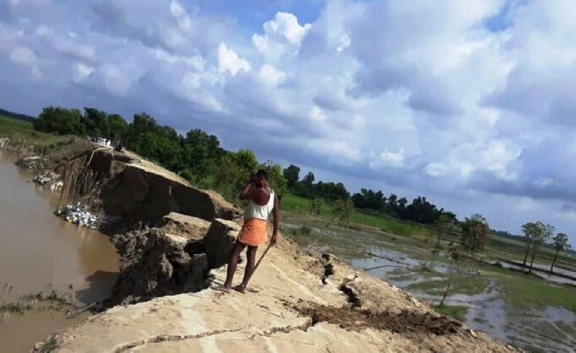 A man standing near a damaged embankment on the banks of the Lal Bakaiya River in Rautahat, on Saturday. Photo: THT