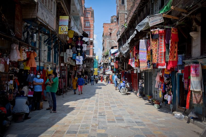 Pedestrians are seen in a re-opened market area after government decided to ease the lockdown in low-risk areas while adopting standard precautions against COVID-19, in Kathmandu, on Friday, June 12, 2020. Photo: Naresh Shrestha/THT