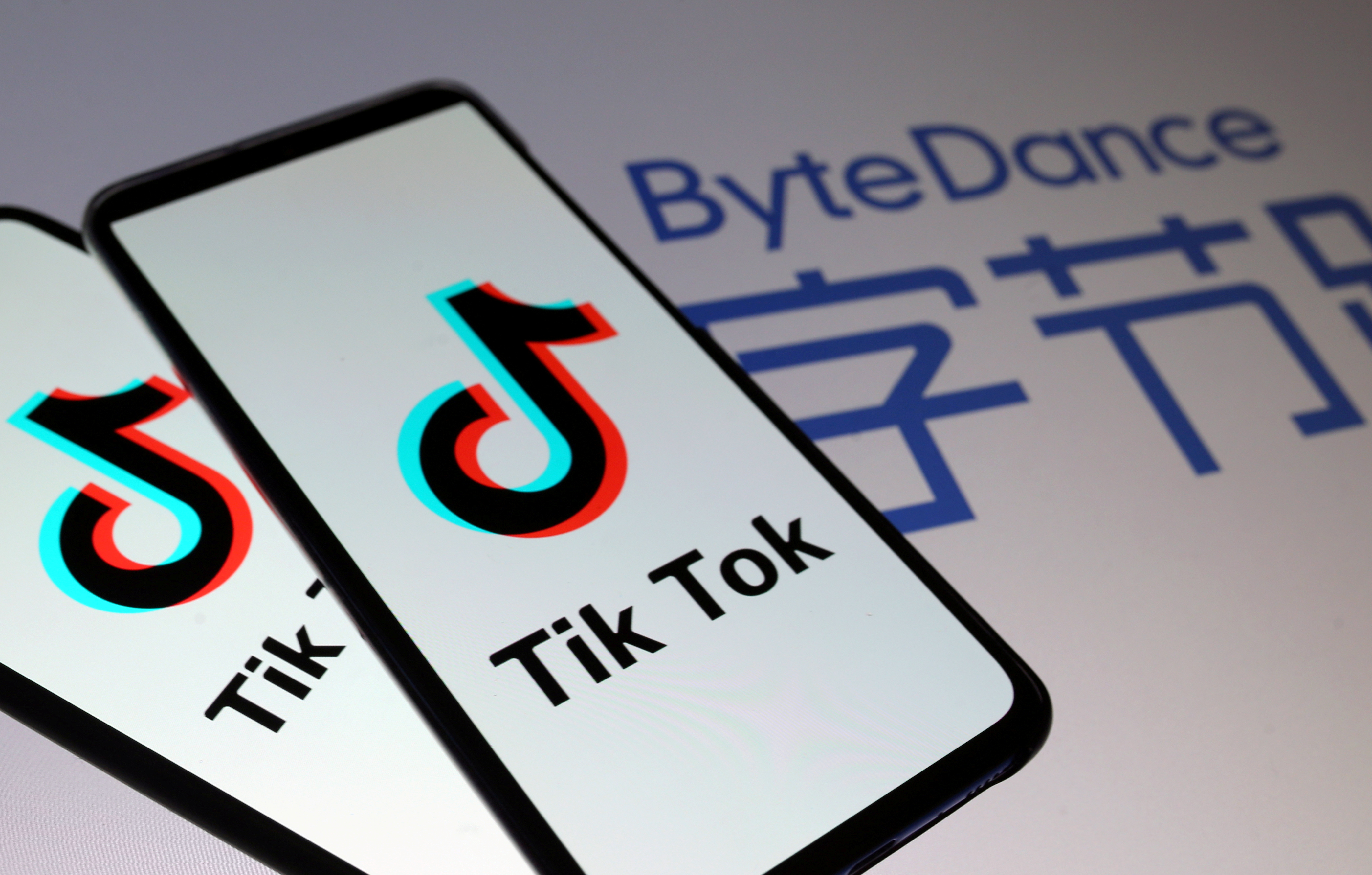 FILE - Tik Tok logos are seen on smartphones in front of a displayed ByteDance logo in this illustration taken November 27, 2019. Photo: Reuters