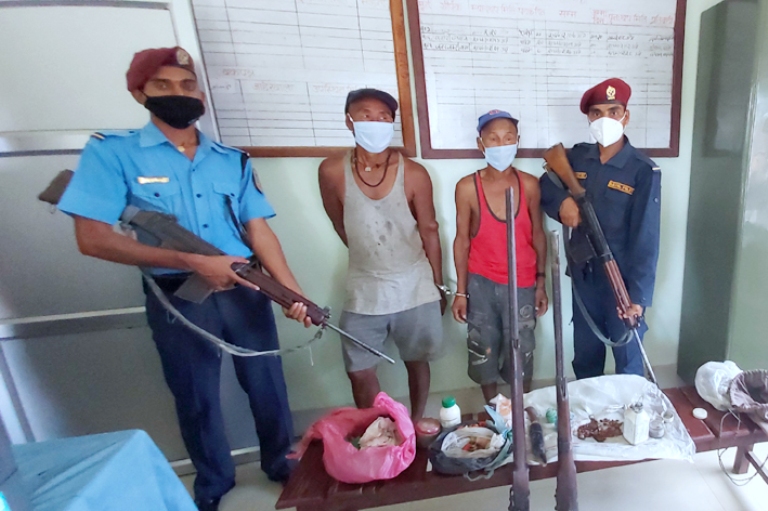 Police making two persons public along with seized arms and ammunition at the DPO Siraha, on Sunday, June 07, 2020. Photo: Aashish BK/THT