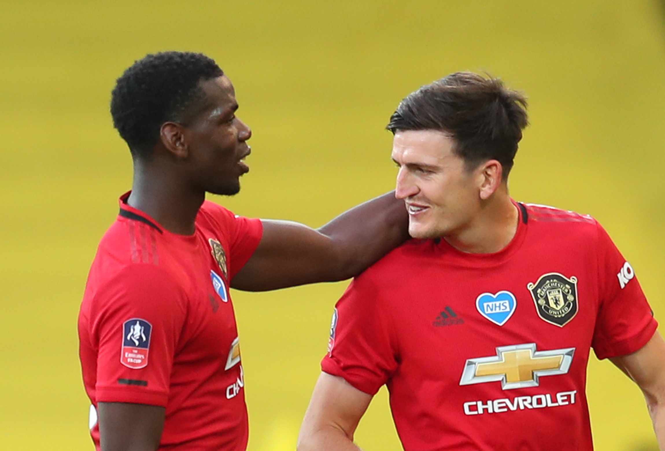 Manchester United's Harry Maguire and Paul Pogba celebrate after the match, as play resumes behind closed doors following the outbreak of the coronavirus disease (COVID-19) during the FA Cup Quarter Final match between Norwich City and Manchester United, at Carrow Road, in Norwich, Britain, on June 27, 2020. Photo: Catherine Ivill/Pool via Reuters