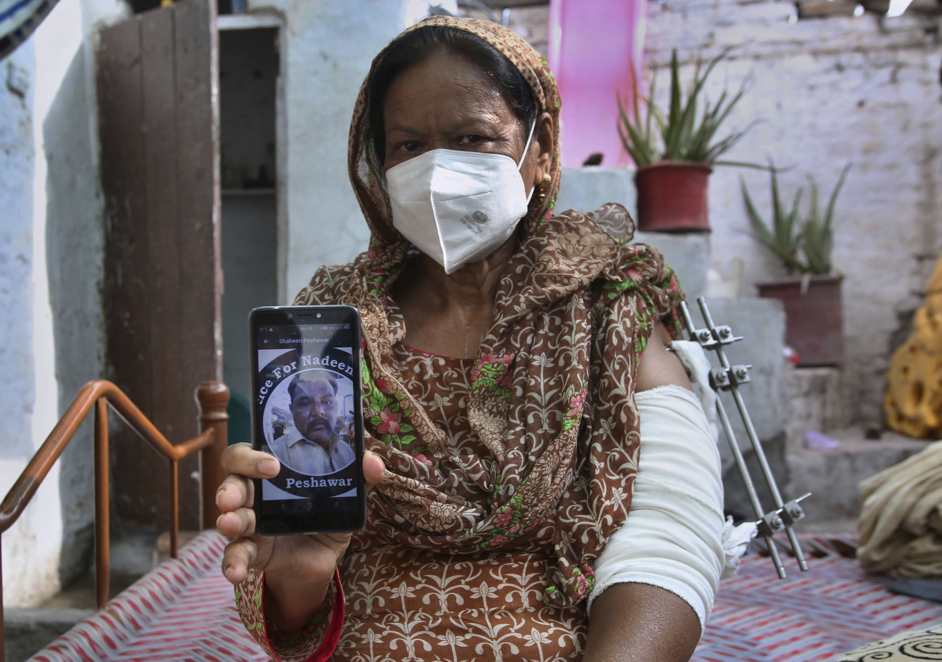 Elizabeth Lal, a Christian woman who was injured and her son-in-law Nadeem Jordon killed by gunmen because he rented in a Muslim neighborhood, shows a picture of Jordon on her mobile during an interview with the Associated Press, in Peshawar, Pakistan, Thursday, July 9, 2020. Analysts and activists say minorities in Pakistan are increasingly vulnerable to Islamic extremists as Prime Minister Imran Khan vacillates between trying to forge a pluralistic nation and his conservative Islamic beliefs. Photo: AP
