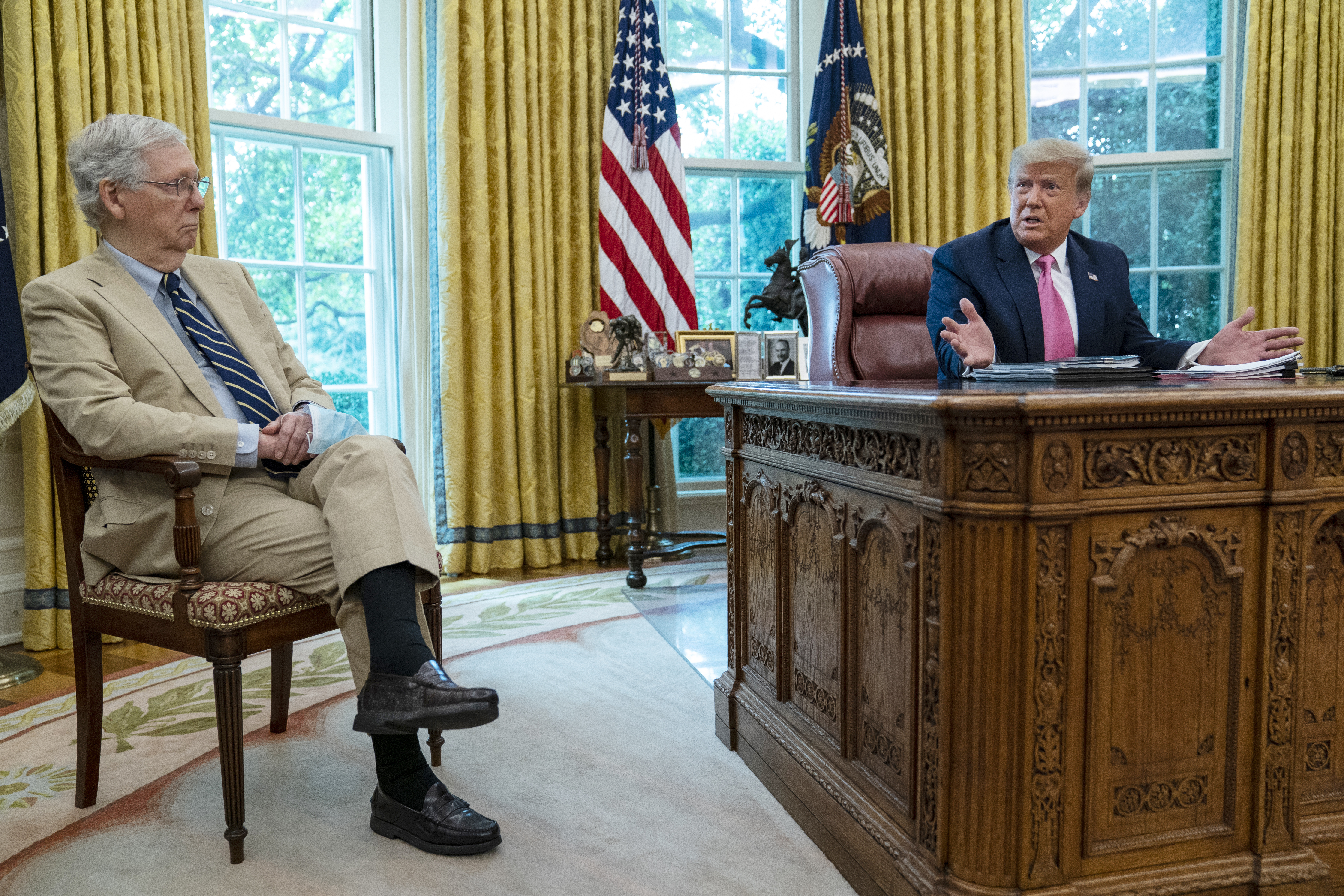 Senate Majority Leader Mitch McConnell of Ky., listens as President Donald Trump speaks during a meeting in the Oval Office of the White House, Monday, July 20, 2020, in Washington. Photo: AP