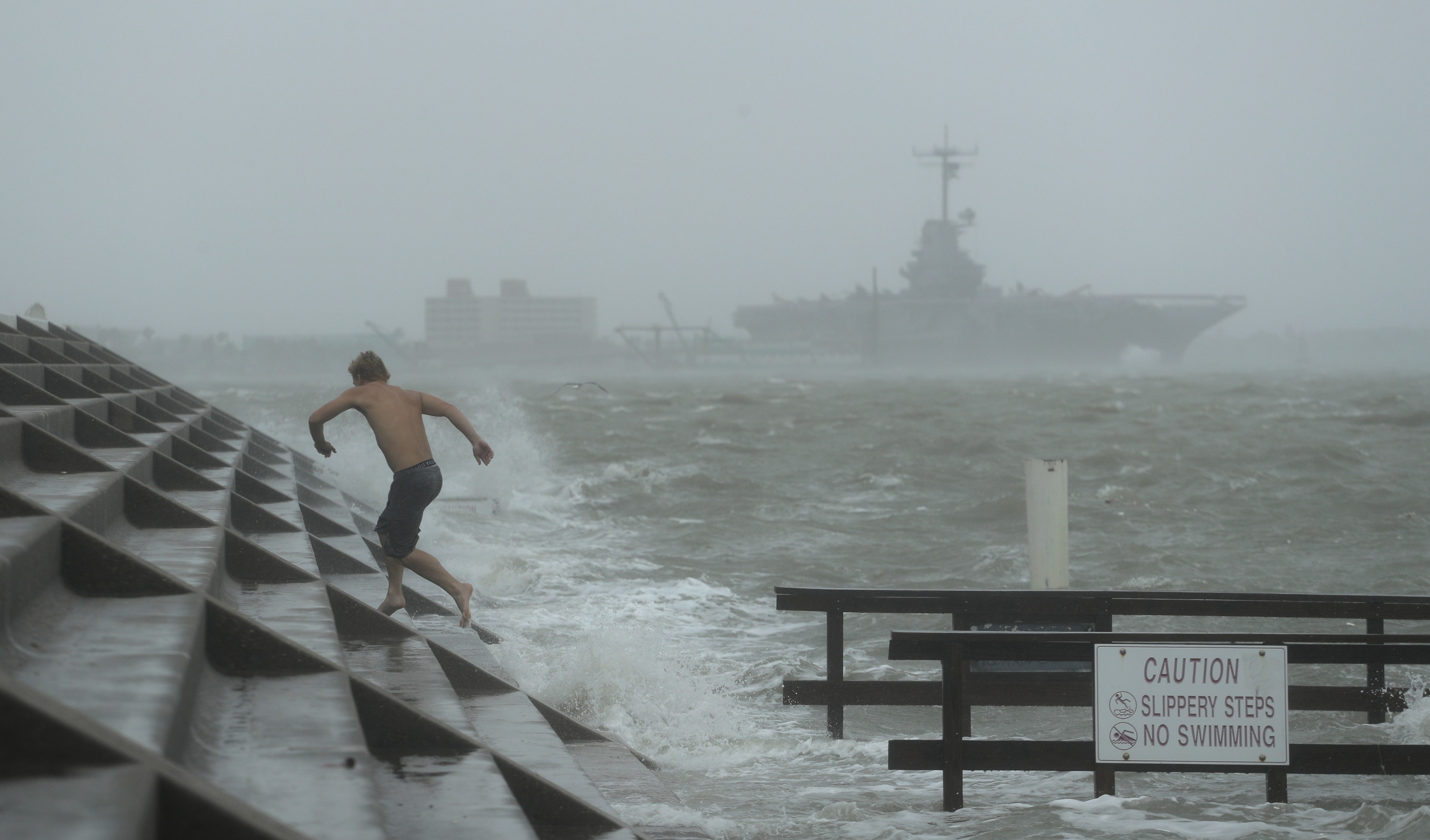 A man jumps from a wave as Hurricane Hanna begins to make landfall, Saturday, July 25, 2020, in Corpus Christi, Texas.   The National Hurricane Center said Saturday morning that Hanna's maximum sustained winds had increased and that it was expected to make landfall Saturday afternoon or early evening. Photo: AP