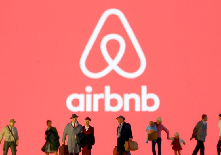 FILE PHOTO: Small toy figures are seen in front of diplayed Airbnb logo in this illustration taken March 19, 2020. Photo: Reuters