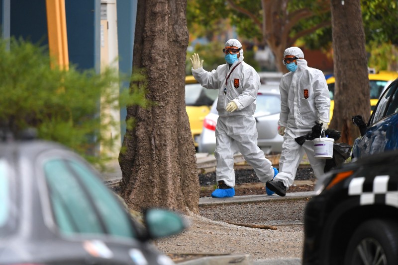 People in hazardous material overalls are seen outside of a public housing tower along Racecourse Road that was placed under lockdown due to the coronavirus disease (COVID-19) outbreak in Melbourne, Australia, July 6, 2020. Photo: AAP Image/James Ross/via Reuters