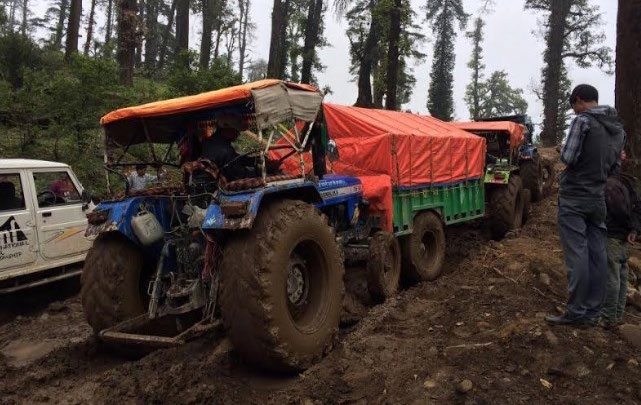 Tractors loaded with relief materials stuck on the way along the Martadi-Kolti road section, in Bajura, on Sunday. Photo: THT