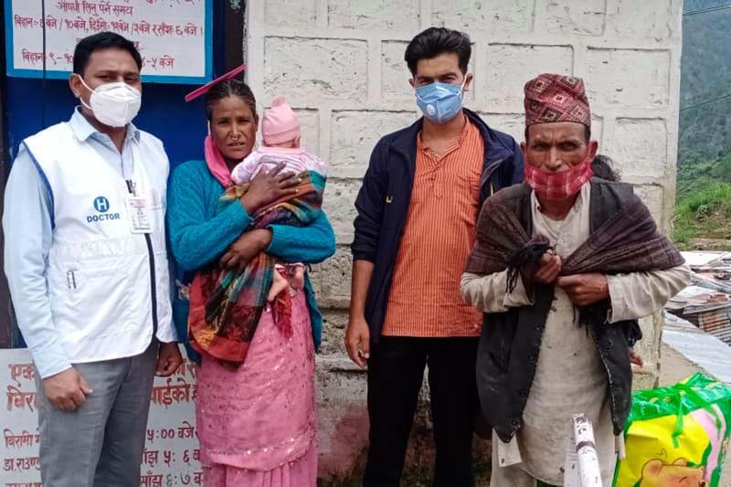 The Himalayan Times' correspondent of Bajura, Prakash singh (third from left) with Purwa Damai (right), his wife and children, the residents of Budhinanda Municipality-1, pose for a photo at District Hospital, Bajura. Photo: THT