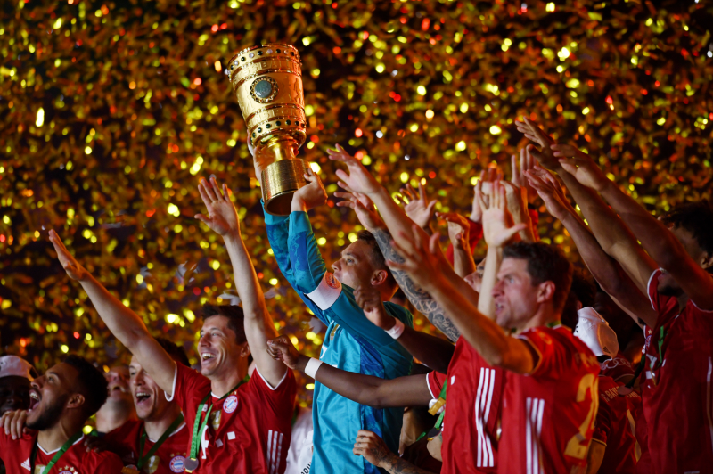 Bayern Munich's Manuel Neuer celebrates with the trophy after winning the DFB Cup, following the resumption of play behind closed doors after the outbreak of the coronavirus disease (COVID-19) after winning DFB Cup Final match between Bayer Leverkusen and Bayern Munich, at  Olympiastadion, in Berlin, Germany, on July 4, 2020. Photo: Reuters