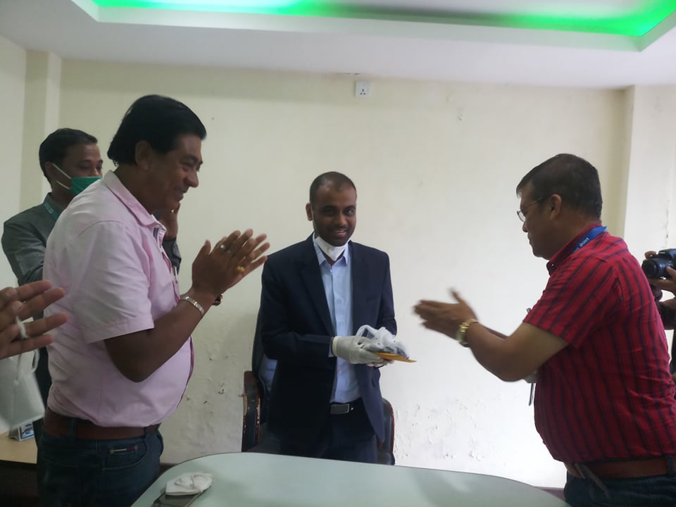 A transport entrepreneur hands over his vehicle key to NMB bank official, in Pokhara, on Monday, July 06, 2020. Photo: Bharat Koirala/THT