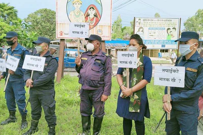 Police taking part in COVID-19 awareness campaign hold placards in Rajbiraj, Saptari, on Wednesday, July 29, 2020. Photo: THT