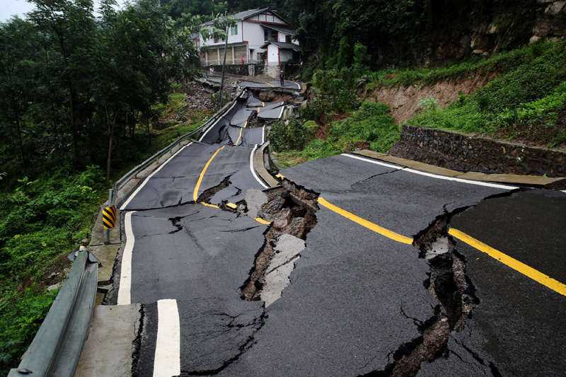 A road damaged by a landslide following heavy rainfall is seen in Chongqing's Qianjiang district, China July 4, 2020. Picture taken July 4, 2020. Photo: China Daily via Reuters