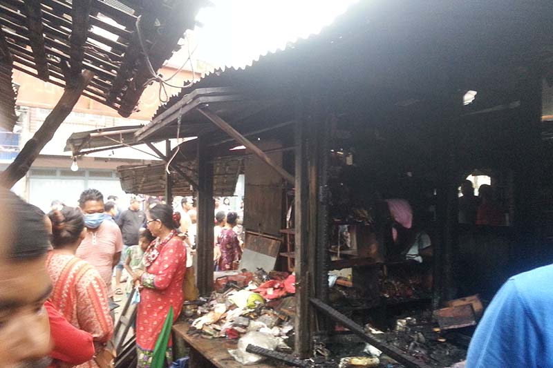 People are seen around the shops gutted in the blaze in Palika vegetable market in Dharan Sub-metropolitan City-3  of Sunsari district, on Monday, July 27, 2020. Photo: Santosh Kafle/THT