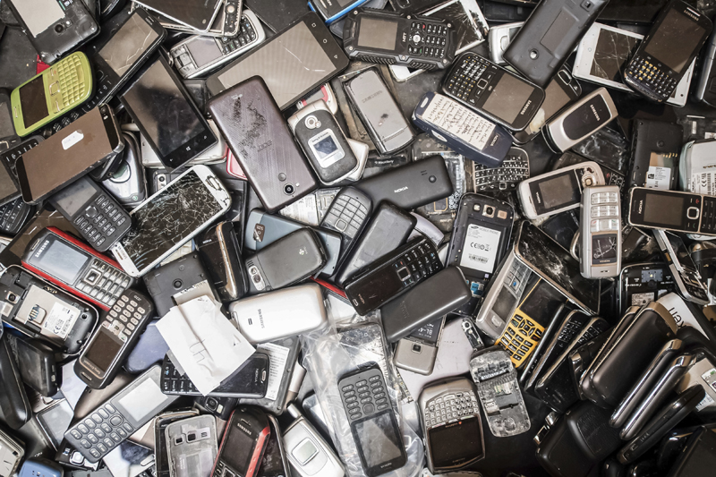 In this photo taken on July 13, 2018, old mobile phones fill a bin at the Out Of Use company warehouse in Beringen, Belgium. The world's mountain of discarded flat-screen TVs, cellphones and other electronic goods grew to a record high last year, according to an annual report released Thursday. Photo: AP