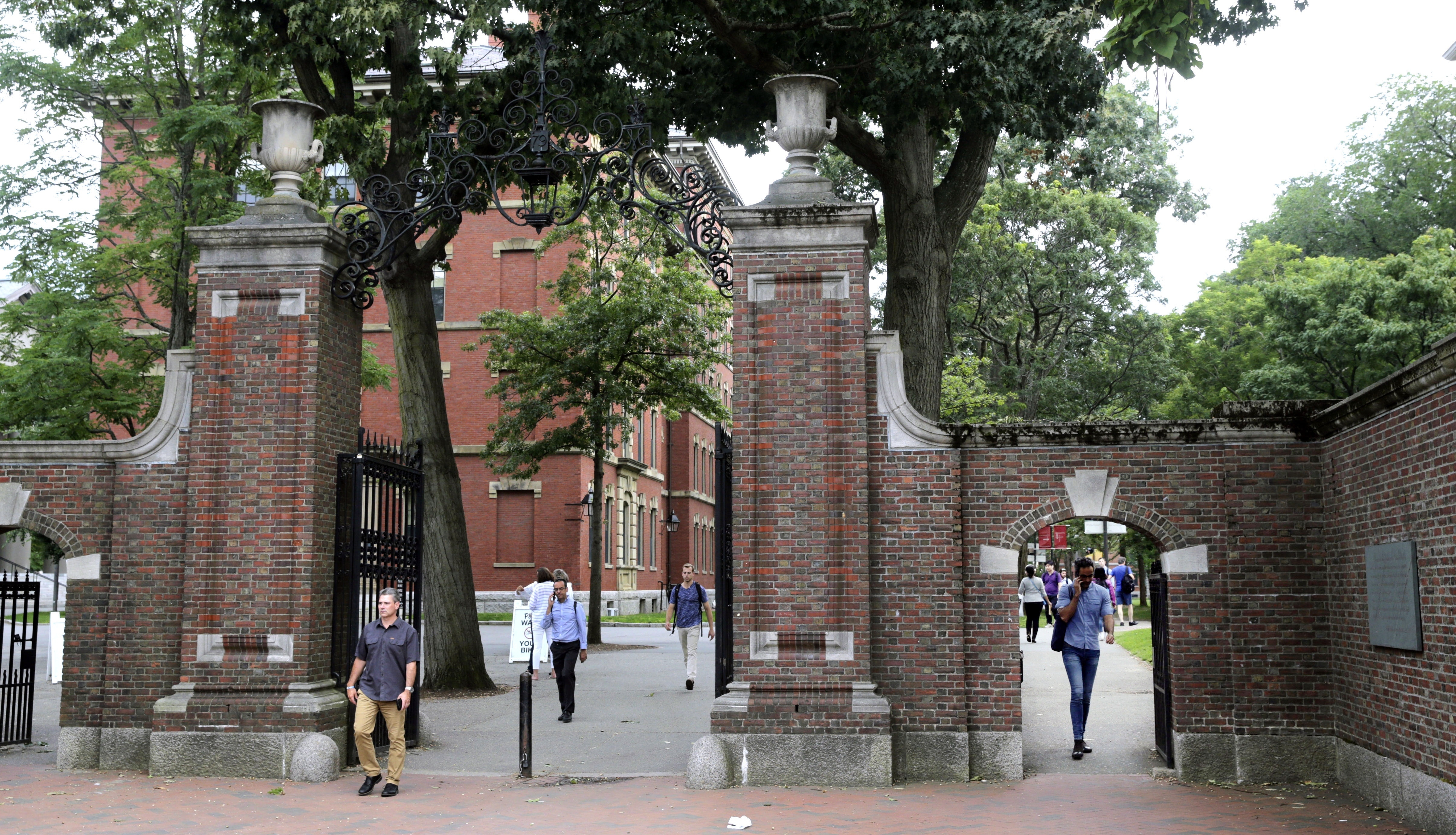  In this August 13, 2019, file photo, pedestrians walk through the gates of Harvard Yard at Harvard University in Cambridge, Mass. Harvard and the Massachusetts Institute of Technology filed a federal lawsuit Wednesday, July 8, 2020, challenging the Trump administration's decision to bar international students from staying in the US if they take classes entirely online this fall.  Photo: AP