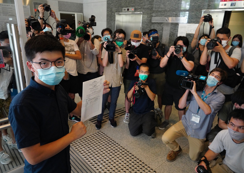 Hong Kong pro-democracy activist Joshua Wong poses for a picture with the nomination papers as he files his candidacy in Legislative Council elections due in September in Hong Kong Monday, July 20, 2020. Photo: AP