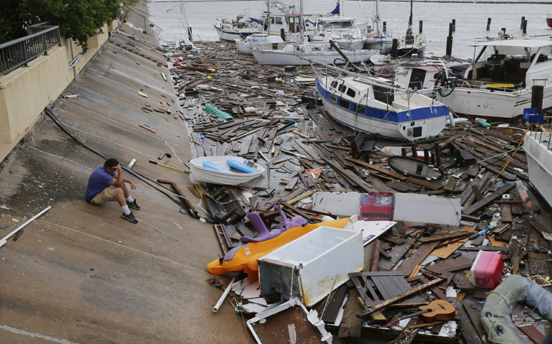Allen Heath surveys the damage to a private marina after it was hit by Hurricane Hanna, Sunday, July 26, 2020, in Corpus Christi, Texas. Heath's boat and about 30 others were lost or damaged. Photo: AP