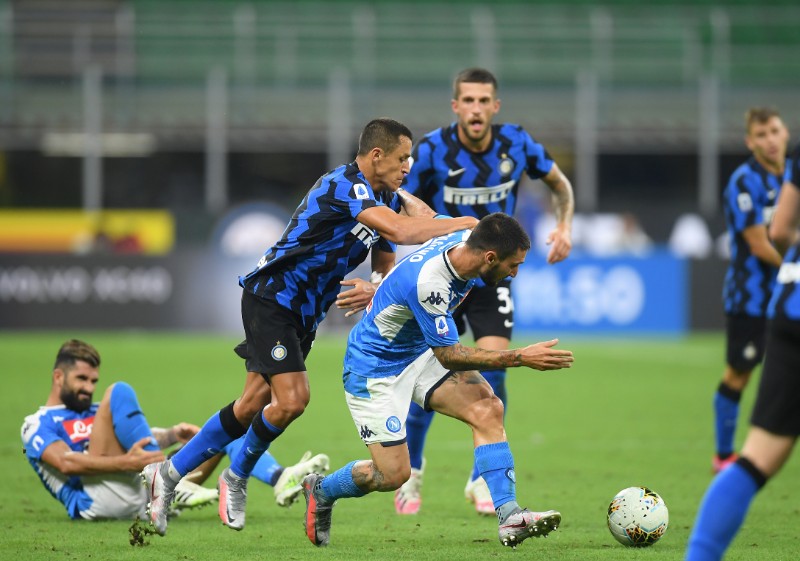Napoli's Matteo Politano in action with Inter Milan's Alexis Sanchez during their Serie A match at San Siro, in Milan, Italy, on July 28, 2020, as play resumes behind closed doors following the outbreak of the coronavirus disease (COVID-19). Photo: Reuters