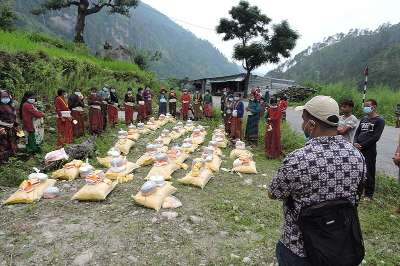 International Nepal Fellowship (INF), Bajura officers about to distribute relief items to the poor families in Rapka, Badimalika Municipality-8, on Thursday, July 23, 2020. Photo: Prakash Singh/THT