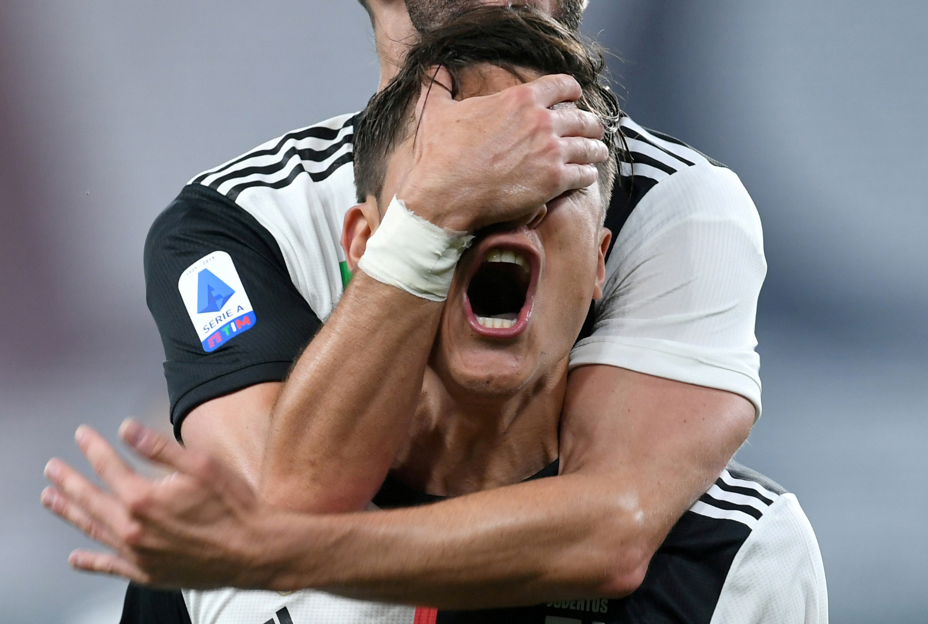 Juventus' Paulo Dybala celebrates scoring their first goal with Miralem Pjanic, as play resumes behind closed doors following the outbreak of the coronavirus disease (COVID-19) during the Serie A match between Genoa and Juventus, at Stadio Comunale Luigi Ferraris, in Genoa, Italy, on June 30, 2020. Photo: Reuters