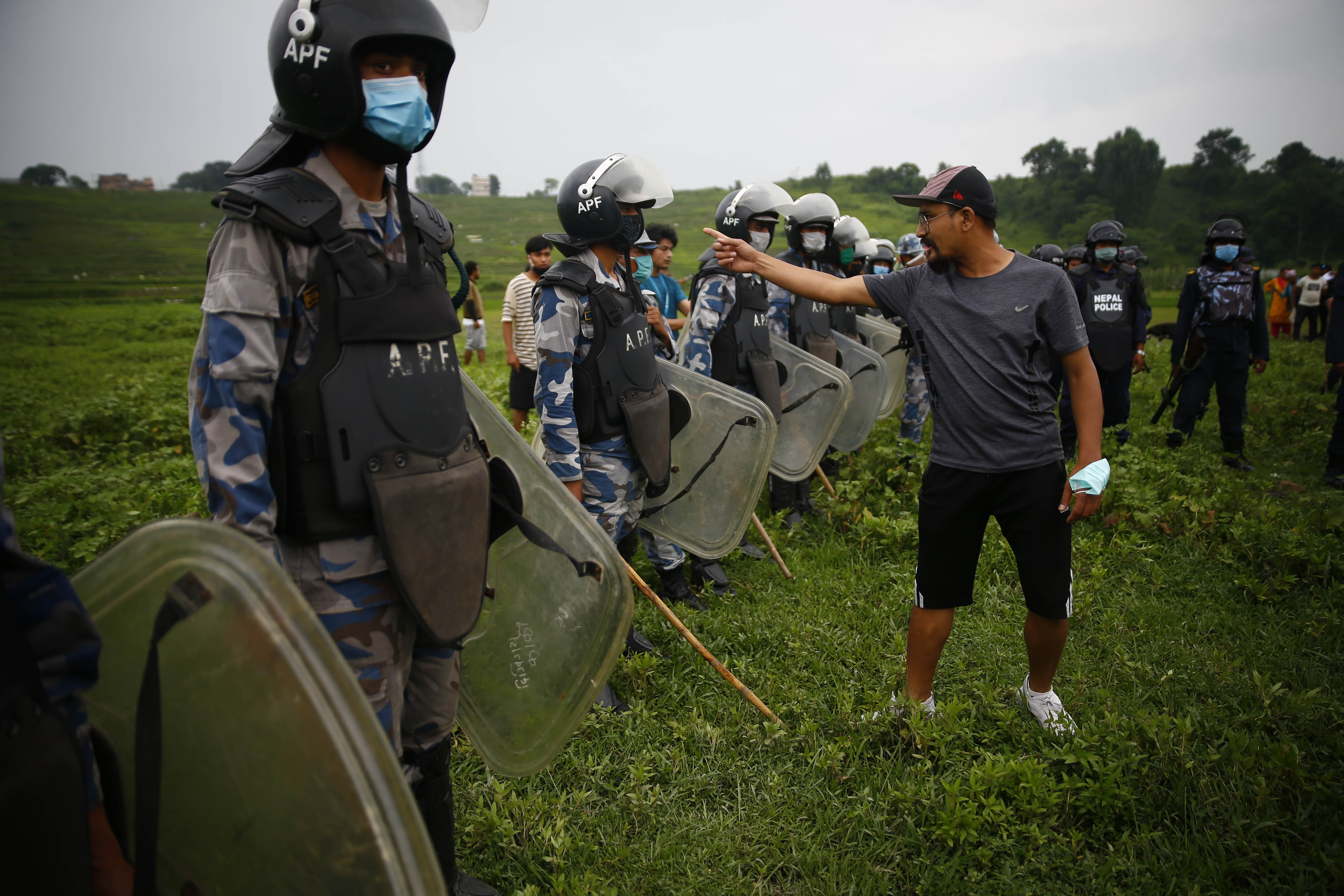 Locals from Kathmandu, Bhaktapur and Lalitpur clash with Armed Police Force and Riot Police personnel during a protest at Khokana, in Lalitpur, on Saturday, July 4, 2020. The local communities of Khokana and Bungamati area are concerned about the damage that the Fast-Track construction could cause to their properties, land, and cultural rights. Photo: Skanda Gautam/THT