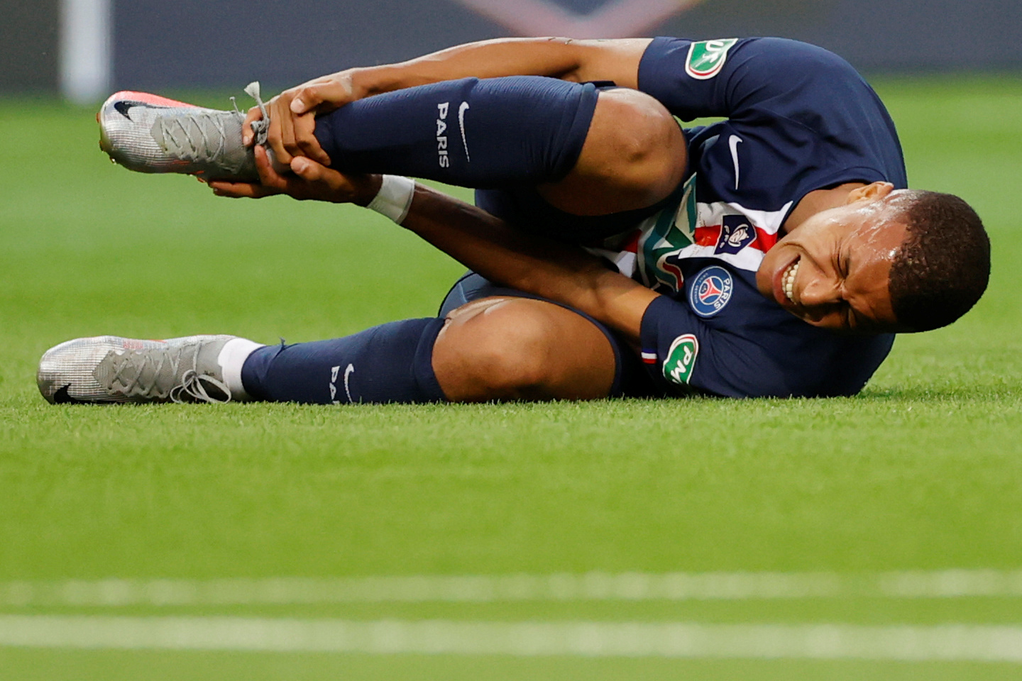 Paris St Germain's Kylian Mbappe reacts after sustaining an injury, following the outbreak of the coronavirus disease (COVID-19). Photo: Reuters  