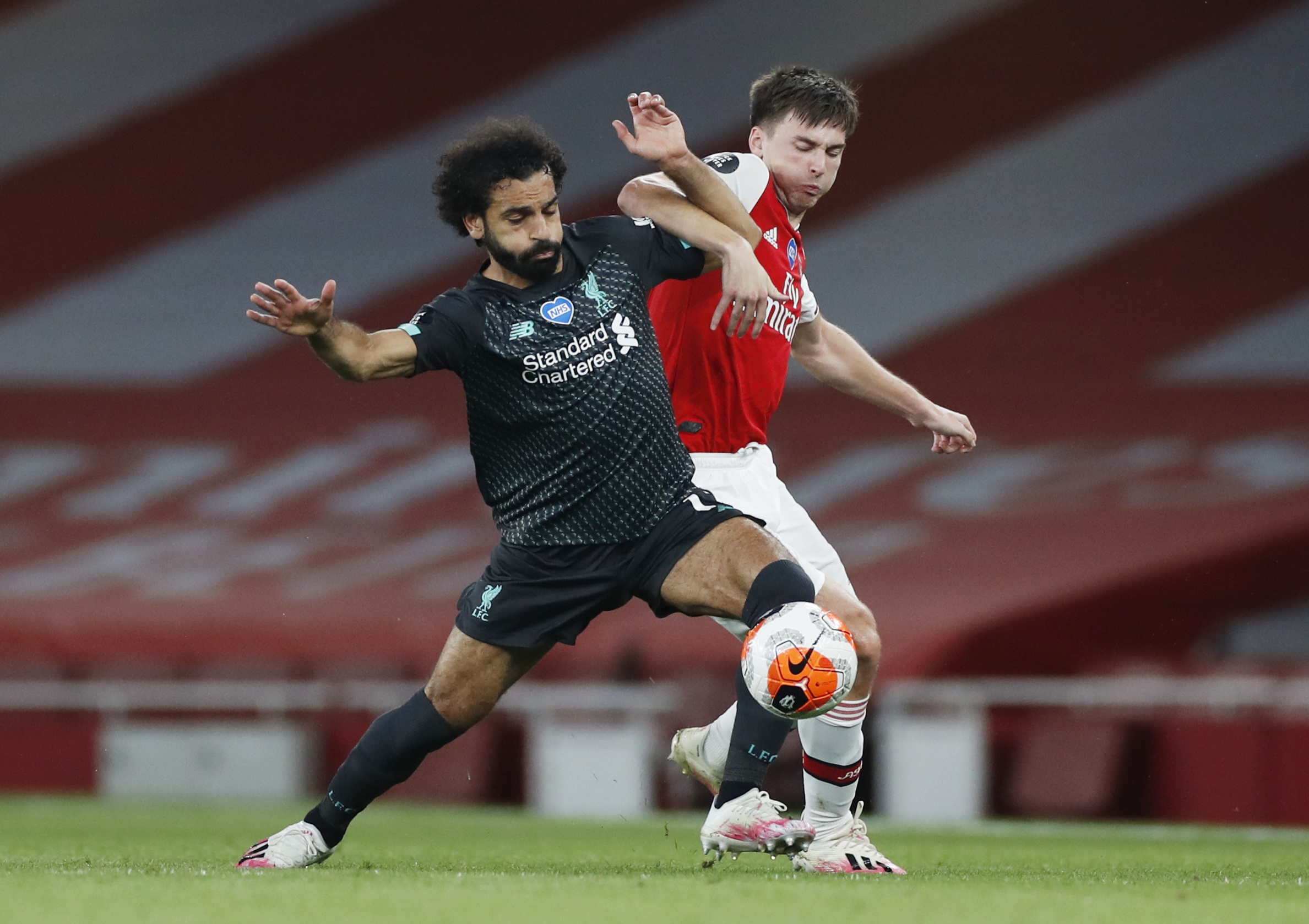 Liverpool's Mohamed Salah in action with Arsenal's Kieran Tierney, as play resumes behind closed doors following the outbreak of the coronavirus disease (COVID-19). Photo: Reuters