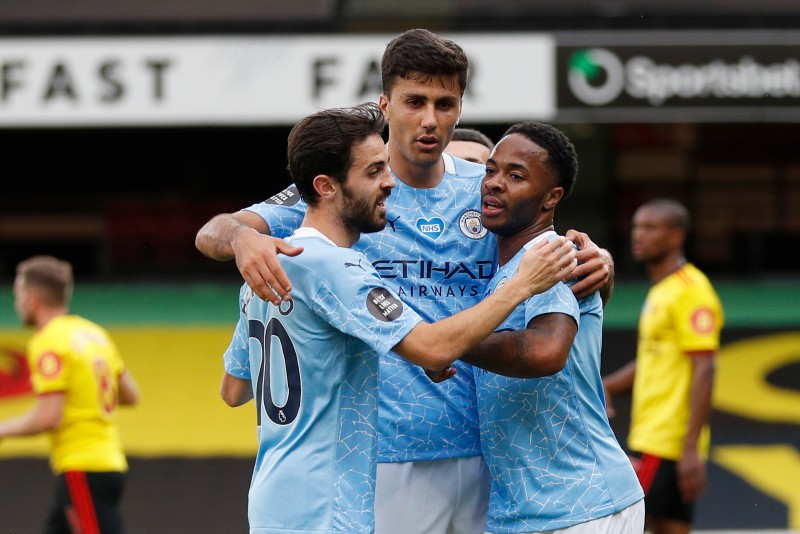 Manchester City's Raheem Sterling celebrates scoring their first goal with teammates during the Premier League match between Watford and Manchester City, at Vicarage Road, in Watford, Britain, on July 21, 2020, as play resumes behind closed doors following the outbreak of the coronavirus disease (COVID-19). Photo: Pool via Reuters.