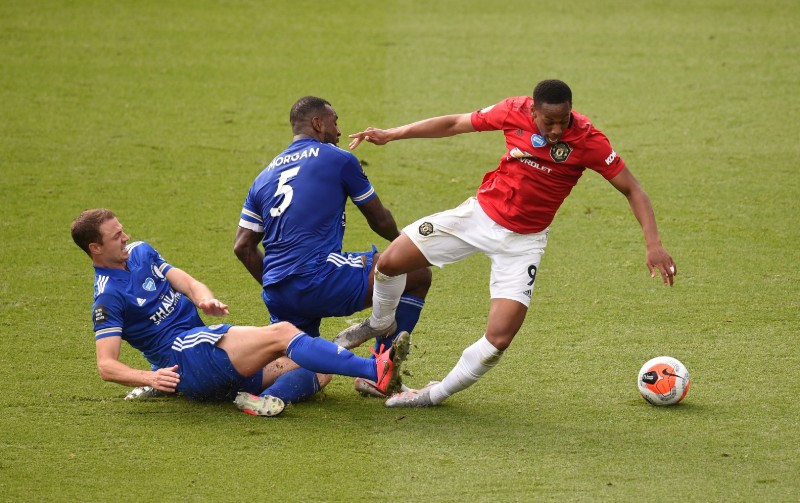 Manchester United's Anthony Martial is brought down by a challenge by Leicester City's Jonny Evans and Wes Morgan resulting in a penalty to Manchester United during their Premier League match, at King Power Stadium, in Leicester, Britain, on July 26, 2020, as play resumes behind closed doors following the outbreak of the coronavirus disease (COVID-19). Photo:  Pool via Reuters