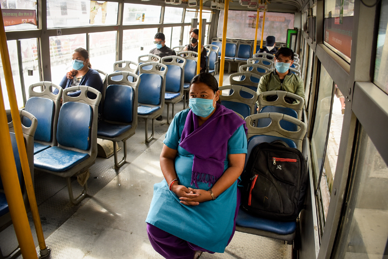 Passengers travelling on a Sajha Yatayat bus maintain physical distance, as restrictions on public transportation are eased by the government, in Lalitpur, on Thursday, July 16, 2020. Photo: Naresh Shrestha/THT