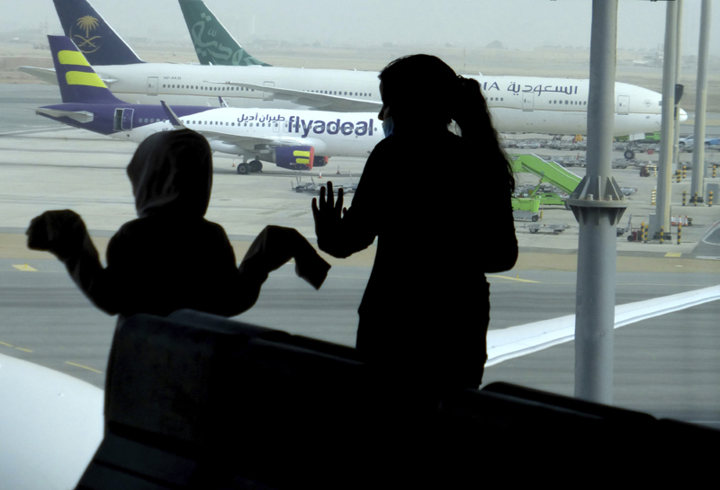 Passengers watch aircraft on the tarmac as they wait for their flight at the King Abdulaziz International Airport in Jiddah, Saudi Arabia, Tuesday, July 28, 2020.  Photo: AP