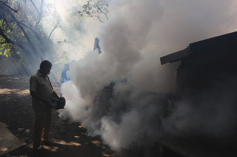 A Mumbai Municipal Corp. worker fumigates a street in Mumbai, India, Wednesday, June 10, 2020. Photo: AP