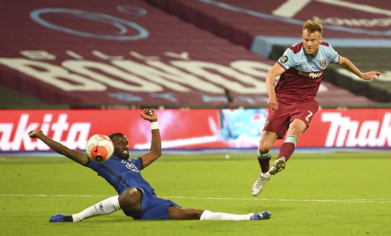 West Ham's Andriy Yarmolenko (right) shoots and scores this sides third goal past Chelsea's Antonio Rudiger during the English Premier League soccer match between West Ham United and Chelsea at the London Stadium stadium in London, on Wednesday, July 1, 2020. West Ham won the match 3-2. Photo: Michael Regan/Pool via AP