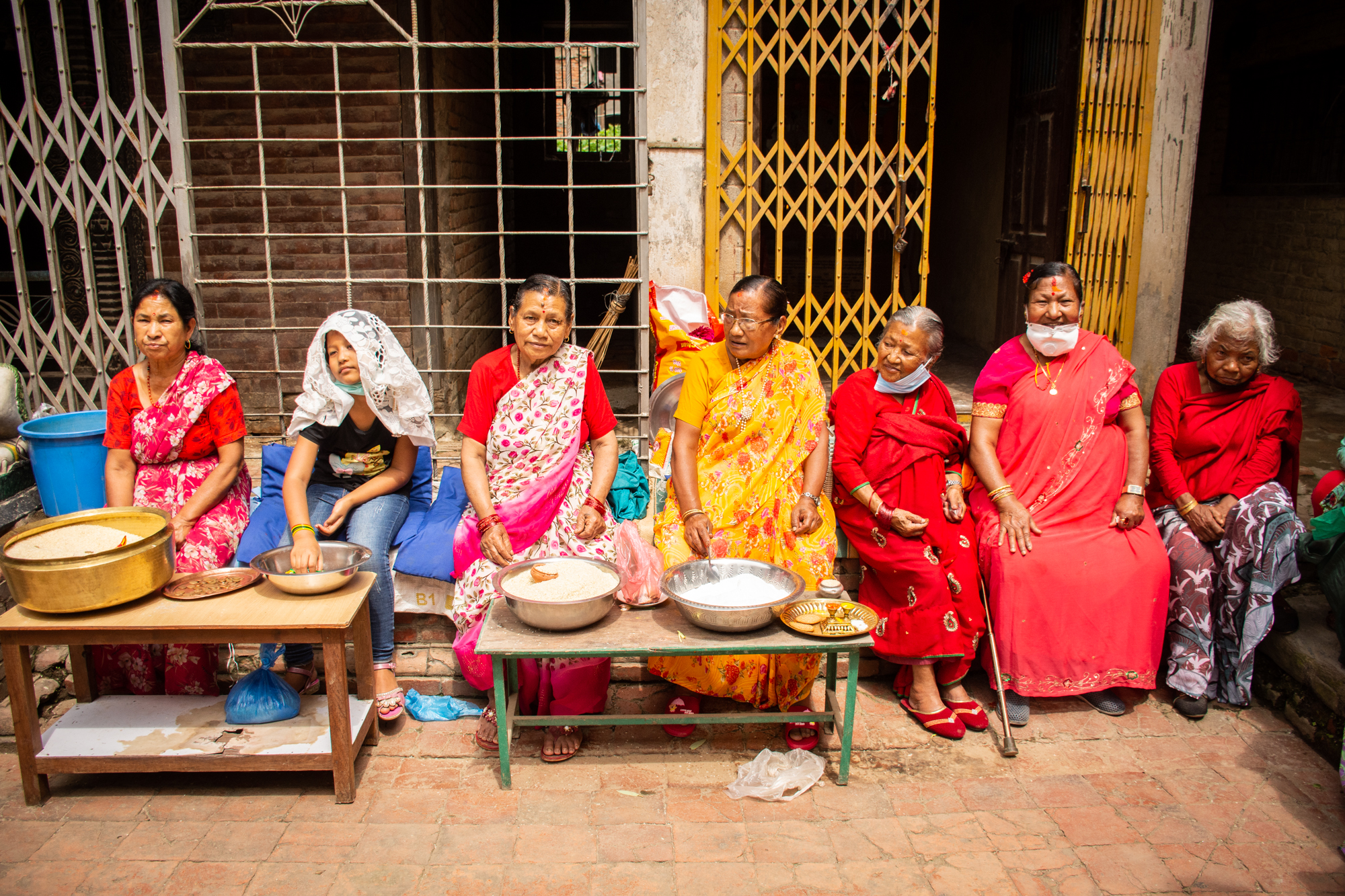 Buddhist devotees wait for offerings during the Pancha Daan festival in Lalitpur, on Tuesday, July 28, 2020. Photo: Naresh Shrestha/THT