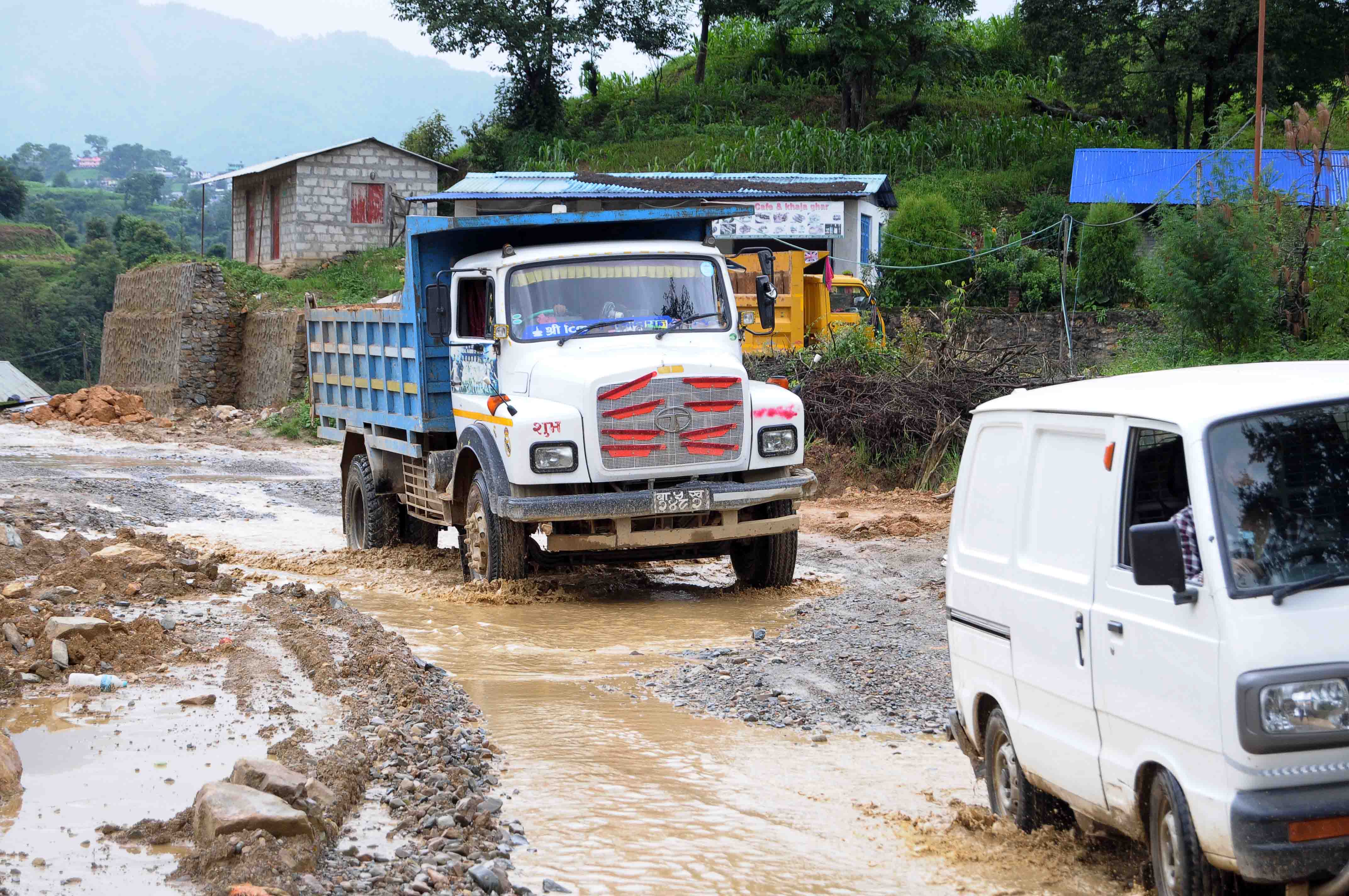 Vehicles wade though puddles along the Tikabhairav-Lele road section, in Lalitpur, on Tuesday, July 7, 2020. Photo: Balkrishna Thapa Chhetri/THT 