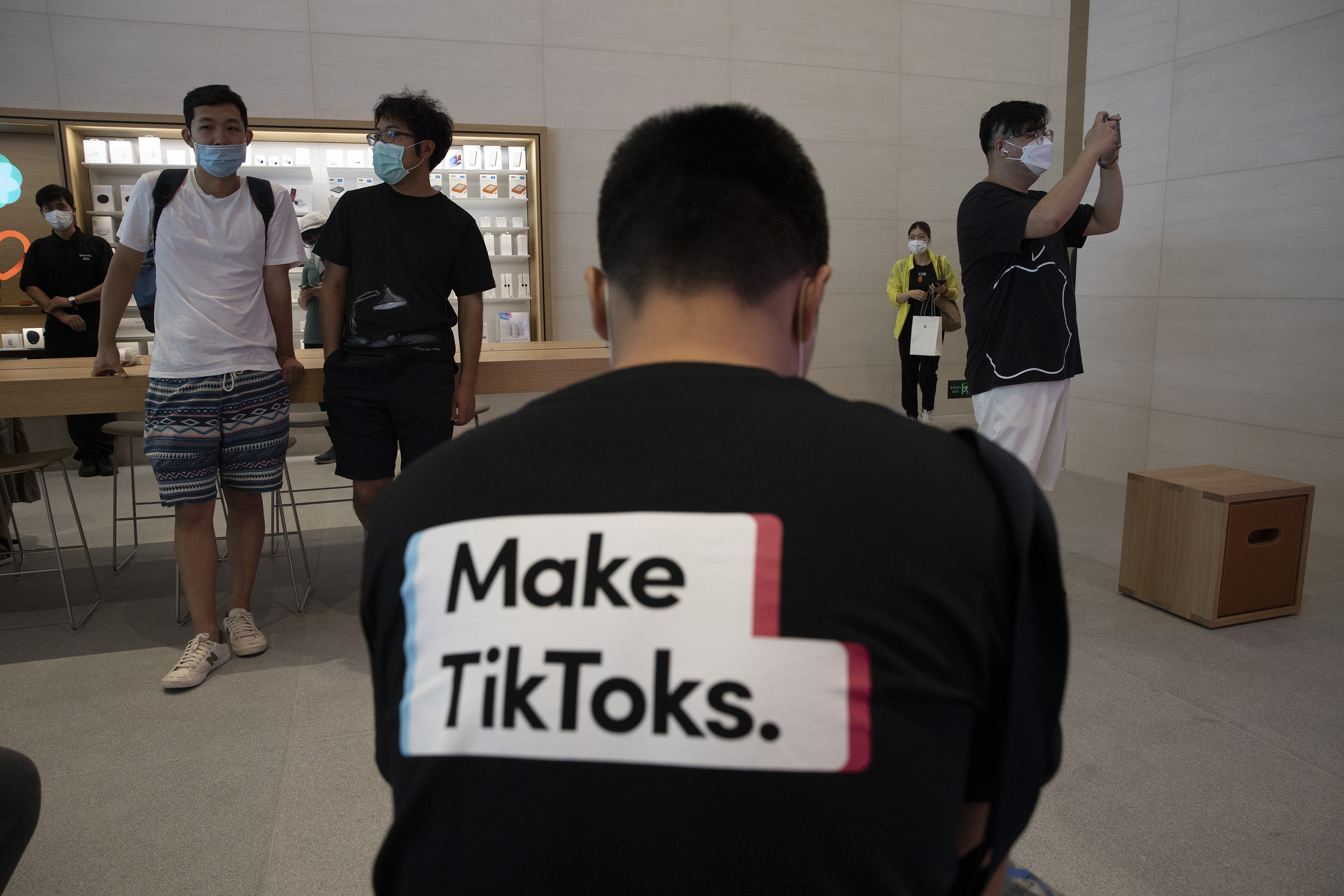A man wearing a shirt promoting TikTok is seen at an Apple store in Beijing on Friday, July 17, 2020. U. S. President Donald Trump says he wants to take action to ban TikTok, a popular Chinese-owned video app that has been a source of national security and censorship concerns. Photo: AP