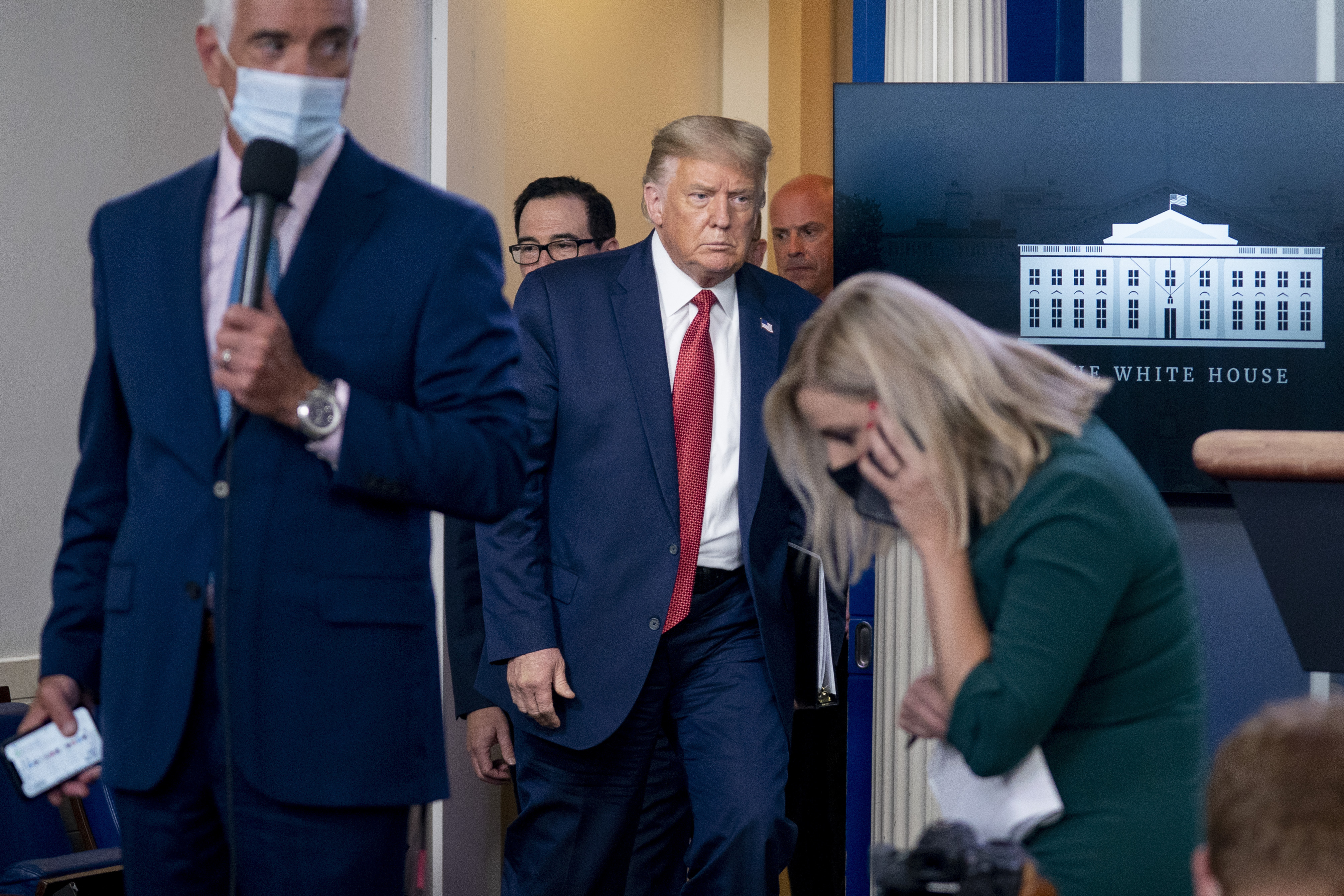 President Donald Trump returns to a news conference in the James Brady Press Briefing Room after he briefly left because of a security incident outside the fence of the White House, Monday, Aug. 10, 2020, in Washington. Photo: AP