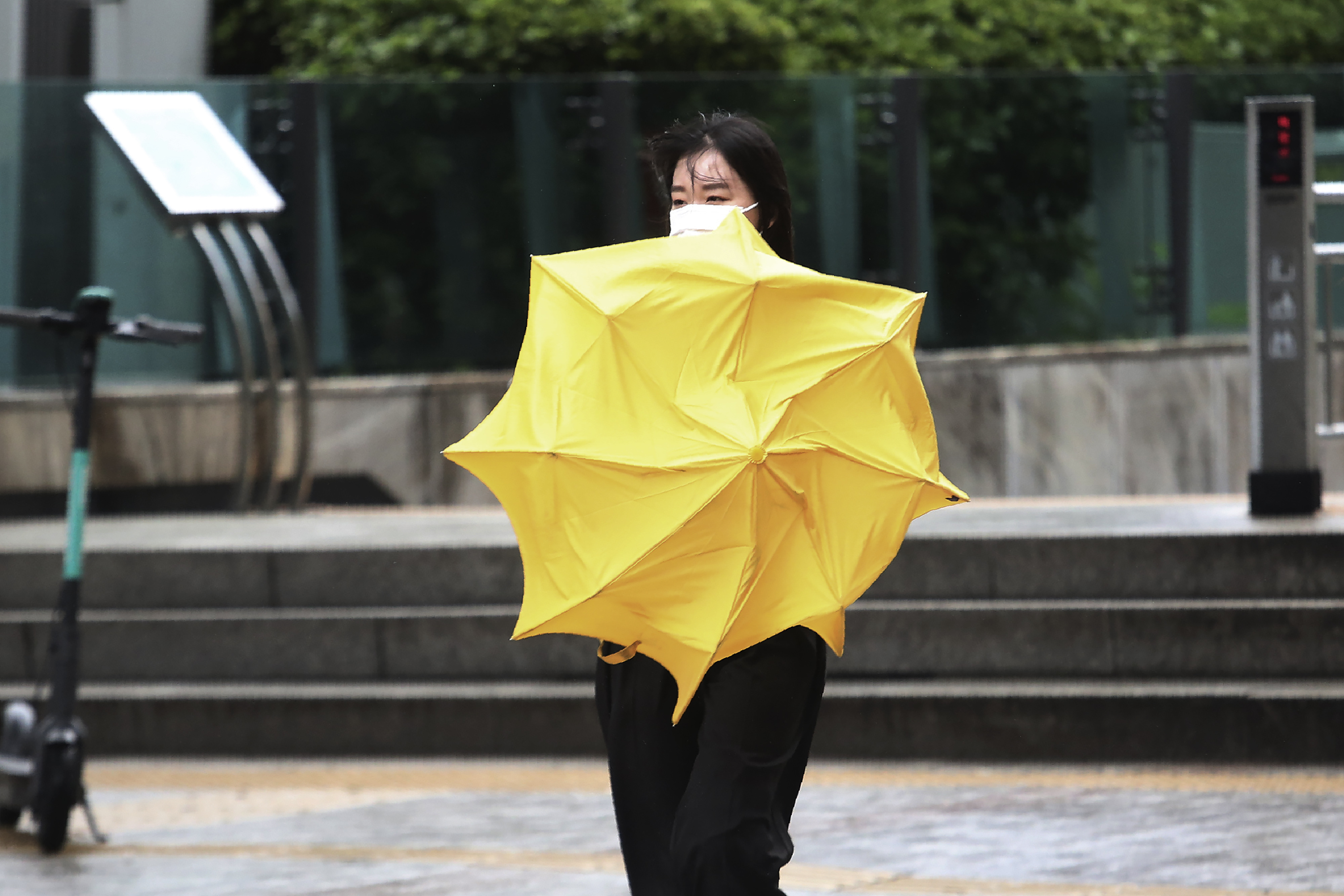 A woman holds an umbrella against the strong wind and rain caused by Typhoon Bavi in Seoul, South Korea, Thursday, Aug. 27, 2020. Typhoon Bavi that grazed South Korea and caused some damage has made landfall in North Korea early Thursday. South Korean authorities said there were no immediate reports of casualties, and North Korea has not reported any damages. Photo: AP
