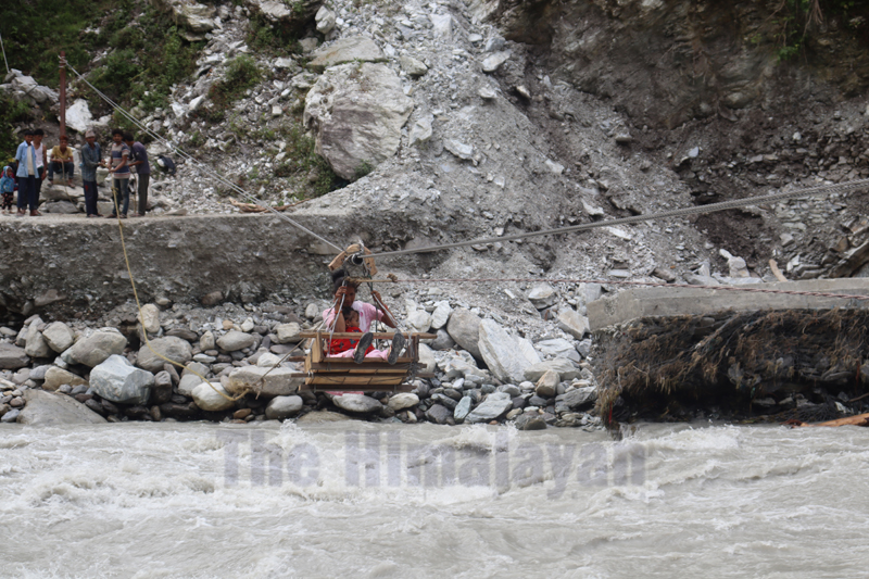 Local crossing the Budhiganga River with the help of a tuin in Jadanga, Bajura, on Sunday, August 23, 2020. Photo: Prakash Singh/THT
