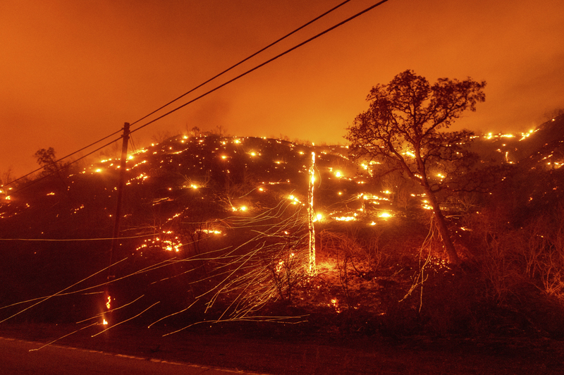 Seen in a long exposure photograph, embers burn along a hillside as the LNU Lightning Complex fires tear through unincorporated Napa County, Calif., on Tuesday, Aug. 18, 2020. Photo: AP