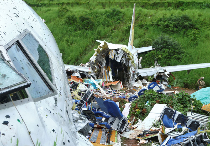 A security official inspects the site where a passenger plane crashed when it overshot the runway at the Calicut International Airport in Karipur, in the southern state of Kerala, India, August 8, 2020. Photo: Reuters