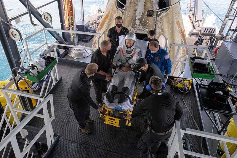 NASA astronaut Douglas Hurley is helped out of the SpaceX Crew Dragon Endeavour spacecraft onboard the SpaceX GO Navigator recovery ship after he and NASA astronaut Robert Behnken landed in the Gulf of Mexico, off the coast of Pensacola, Florida, US, on August 2, 2020. Photo:  NASA/Bill Ingalls/Handout via Reuters